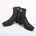 Black vegan suede fluffy flat boots with a soft, cozy appearance.