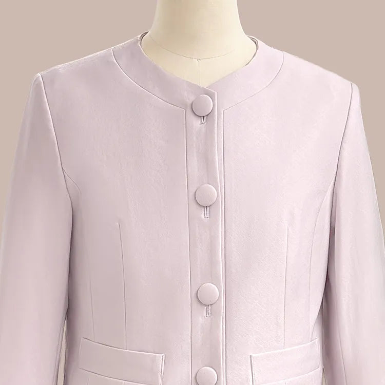 A sleek collarless design that elegantly frames the neckline while creating a flattering face-slimming effect