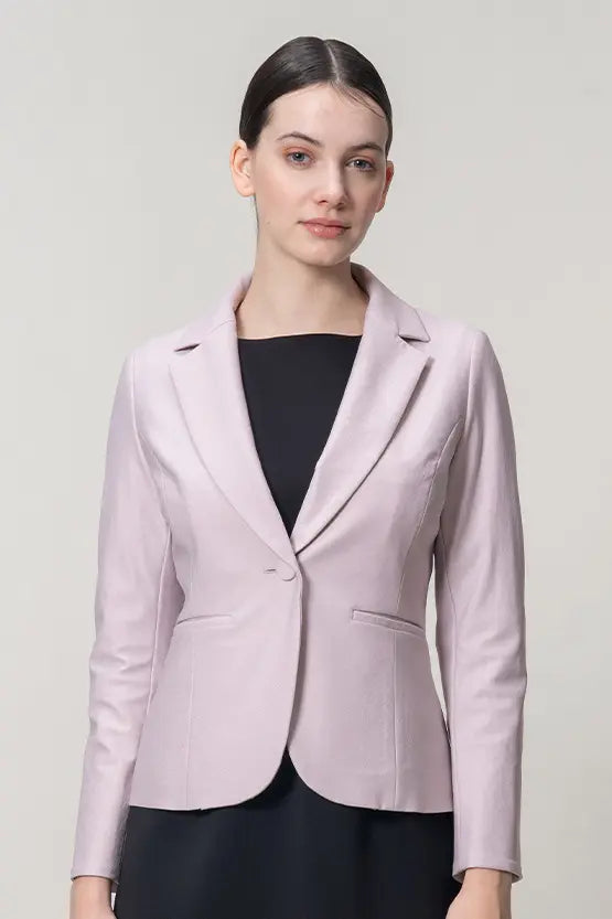 A tailored stretch jacquard jacket in a light, neutral color, showcasing its textured weave and structured silhouette.