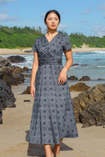 Oshima Tsumugi Design Stretch Jersey Long Marilyn Dress, featuring a dark, intricate Japanese textile pattern.