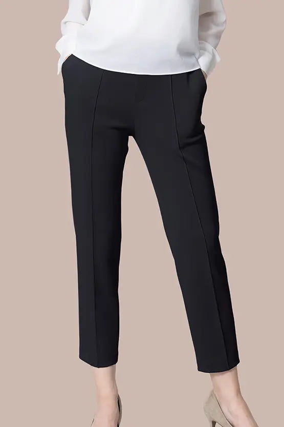 Close-up of Space Material: Tapered Pants in a dark, textured fabric, showing subtle sheen.