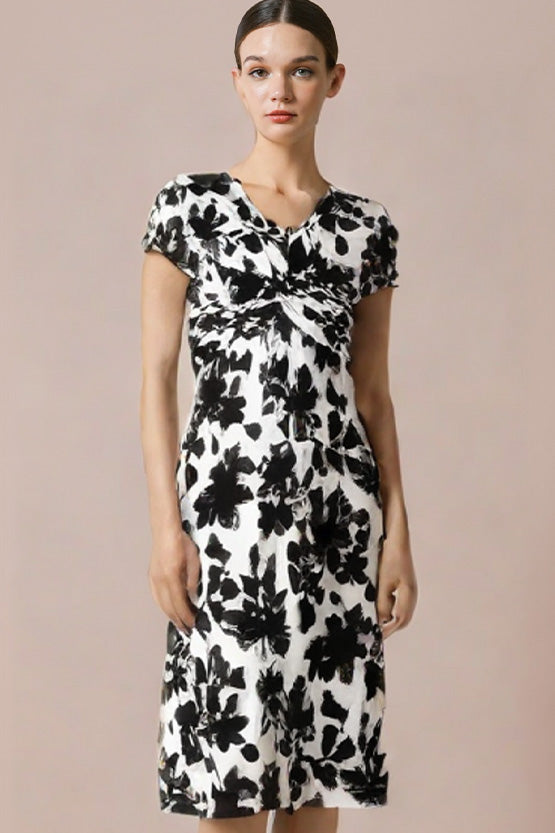 Model in a black Stretch Jersey Twist Dress, showcasing its flattering silhouette and draped neckline.