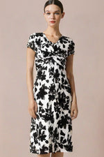 Model in a black Stretch Jersey Twist Dress, showcasing its flattering silhouette and draped neckline.