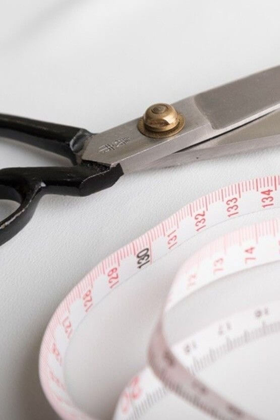 Close-up of hands performing repairs on a device, showing tools and intricate work.