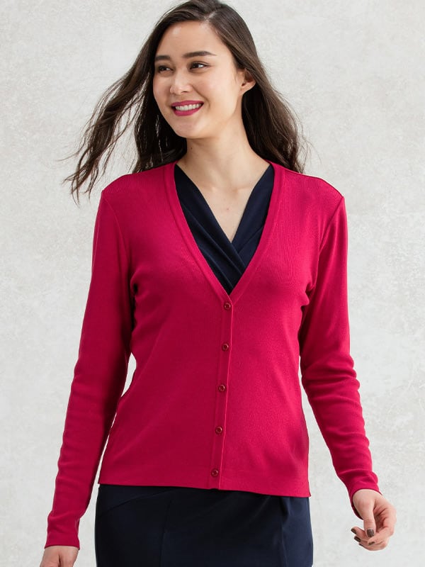 A close-up of a soft red V-neck cardigan, showing the knit texture and button detailing.