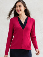 A close-up of a soft red V-neck cardigan, showing the knit texture and button detailing.