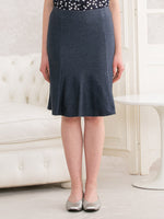 Indigo Stretch Denim Mermaid Skirt: A close-up shot of the skirt's fabric and hem, showcasing its textured indigo wash and