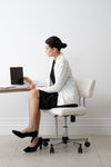 Professional woman wearing white blazer working at office desk in Singapore