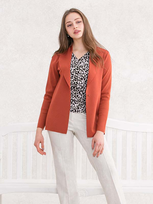 Brick red shawl collar cardigan with a ribbed knit texture and button closure.