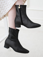 Fluffy black vegan leather flat boots, showcasing soft texture and a comfortable, casual style.