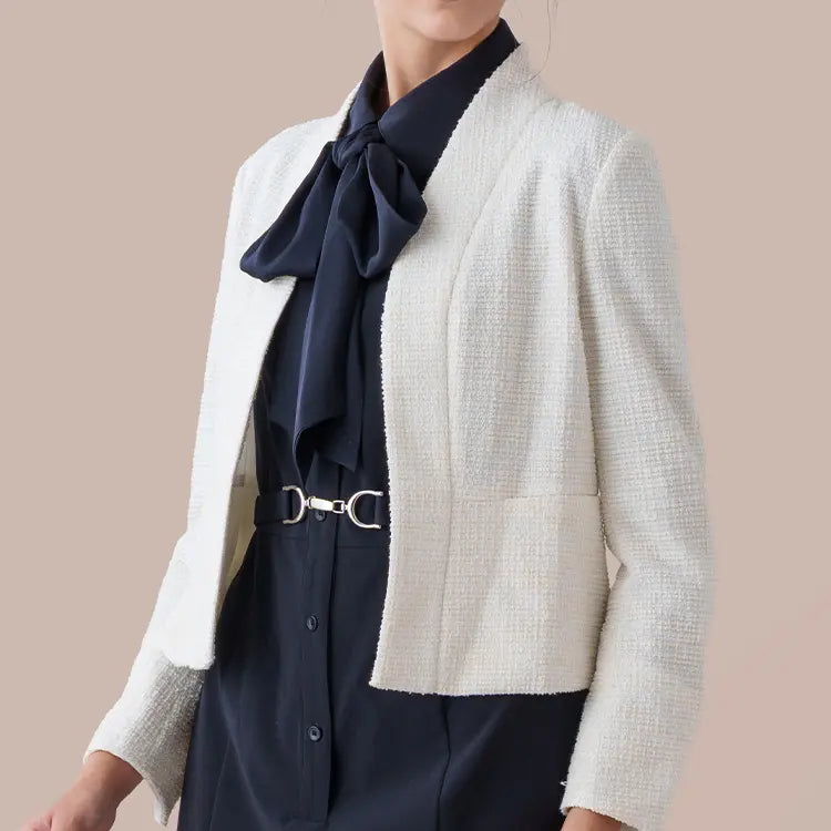 A refined tweed bolero jacket that drapes with effortless luxury