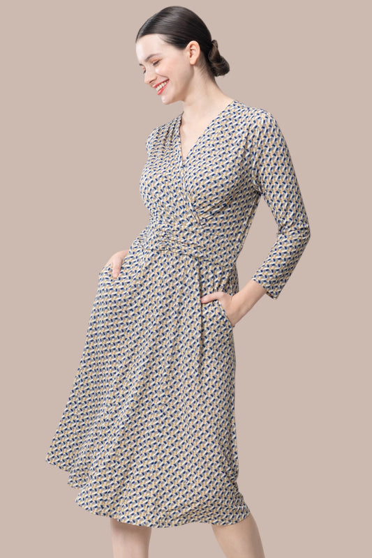 A woman wears the [Stretch Jersey] Mimorin Dress in a vibrant floral print, showcasing its flowy silhouette and knee-length