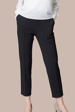 Close-up of Space Material: Tapered Pants in a dark, textured fabric, showing subtle sheen.