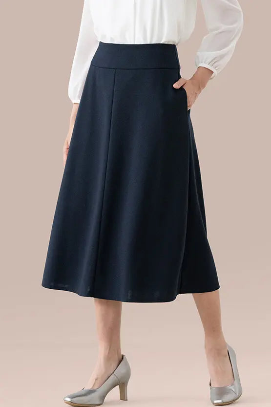 A-line mid-calf Double Jersey skirt in a neutral color, highlighting its smooth fabric and flattering silhouette.