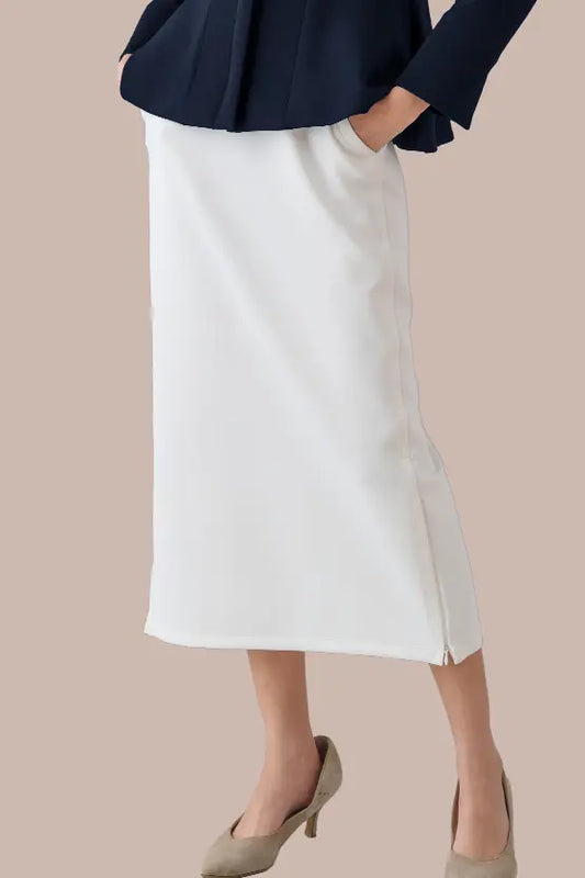 A model wears the Space Material: Straight Skirt, showcasing its sleek, knee-length design in a dark, textured fabric.