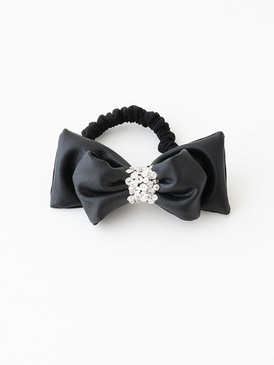 Black vegan leather "puffy" ribbon scrunchie, a soft and voluminous hair accessory.