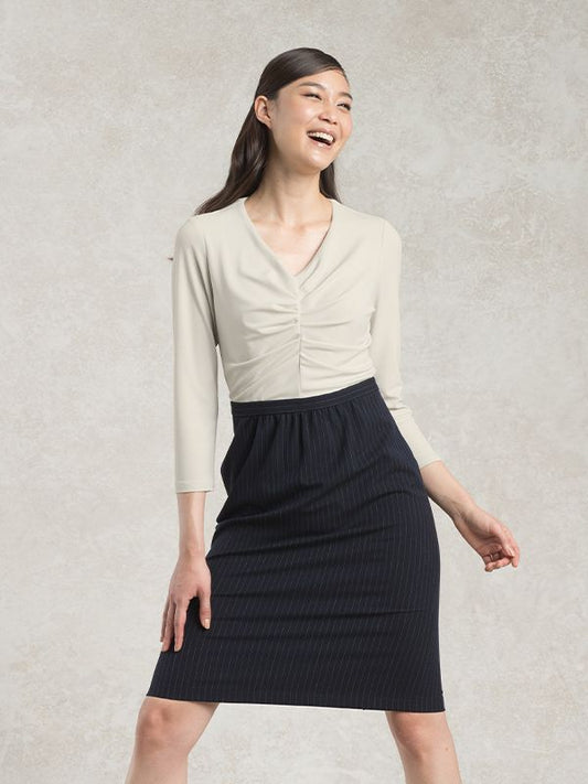 Suit Friendly Soy Milk X Pinstripe Docking Tuck Dress: A woman wears a pinstripe midi dress with a cinched waist.