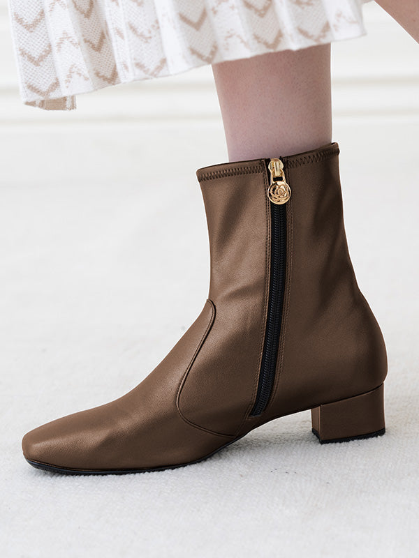 Shiny brown vegan leather fluffy flat boots, a cozy and stylish ankle boot.