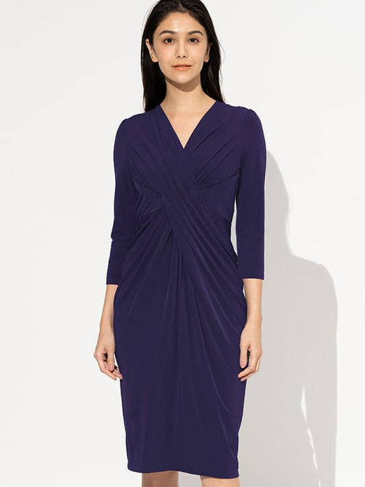 A navy blue 4-Way Stretch: 4-Way Jersey Navy Venus Dress is shown, featuring a flattering neckline and a flowing skirt.