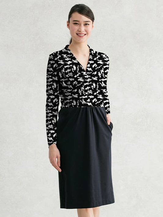 black printed wrap-style top with a black knee-length skirt